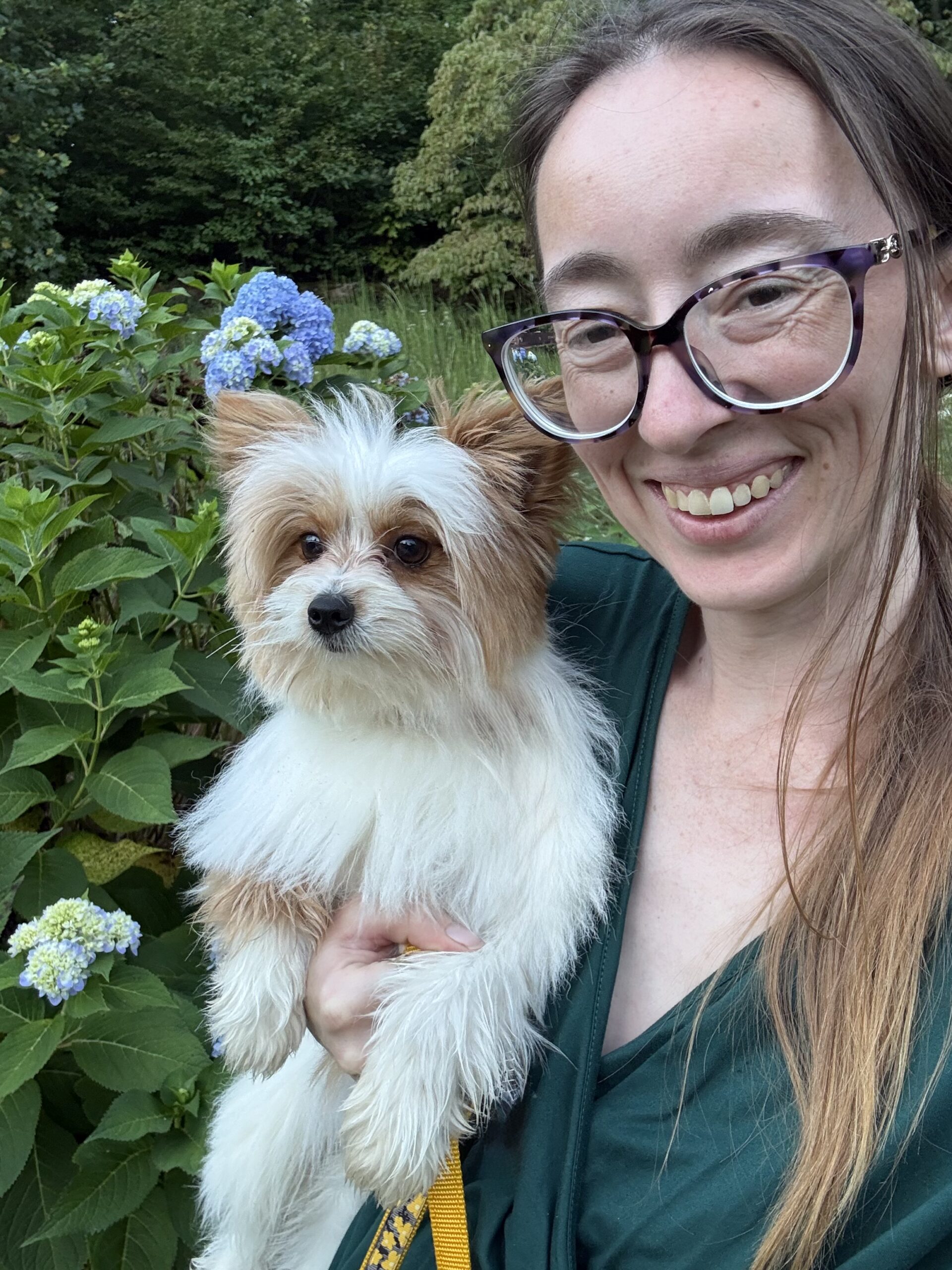 Lauren Elizabeth Gulli working outdoors with an animal at High Caliber K9s farm.